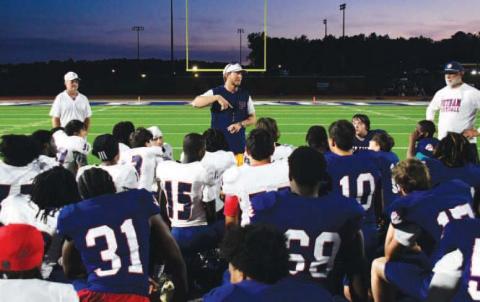 Putnam County High School head football coach Joel Harvin (center) addressed his team following the annual Spring Game to help assess talent and determine positions before the next season begins. IAN TOCHER/Staff