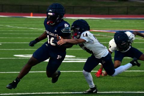 Caption: Putnam County running back Kumari Thomas tries to break a tackle during the team's intrasquad scrimmage on May 15. IAN TOCHER/Staff