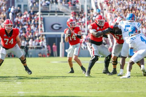 Georgia quarterback Gunner Stockton (14) drops back to pass from the pocket during a game against Ole Miss last season. LANCE McCURLEY/Staff