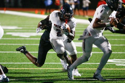 Putnam County junior running back Kumari Thomas (2) shrugs off a Greene County defender as he crosses the goal line for his second touchdown of the game. LANCE MCCURLEY/Staff