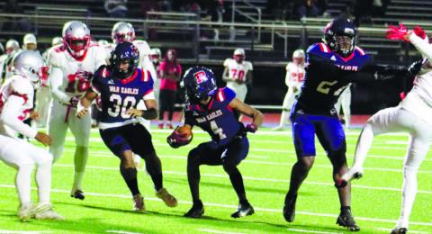 Putnam County wide receiver DJ Bland (4) eyes down a Laney defender while trying to gain yardage downfield in a win on Friday, Oct. 28. ARELLA CASH/Staff