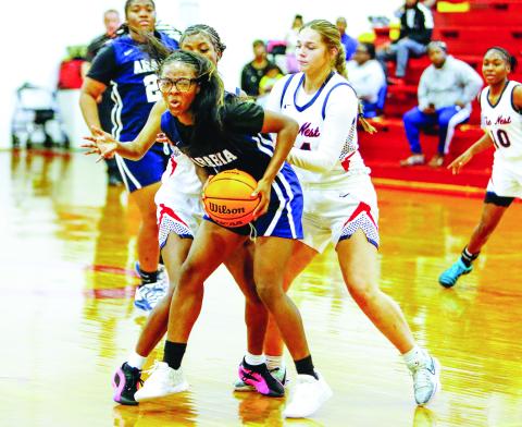 A pair of Putnam County defenders double-team an Arabia Mountain guard as she tries to advance the ball up the court. LANCE McCURLEY/Staff