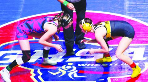 Putnam County’s Lily Armistead (left) gets set to take on Harris County’s Ava Ives (right) in the first round of the GHSA girls state traditionals wrestling tournament last week. KIM CASH/Contributed