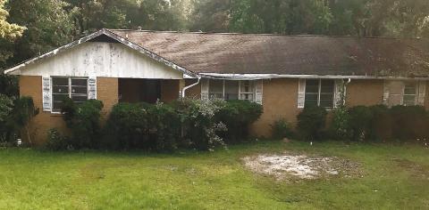 The scenery around this house on the corner of Pennington Road and Peachtree Avenue in Milledgeville seems peaceful after multiple law enforcement agencies conducted a raid on it early Tuesday morning. CONTRIBUTED
