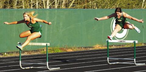 Seniors Anna Williamson (left) and Madison Hevesy compete for Gatewood in the girls’ 300-meter hurdles, with Hevesy finishing second while Williamson placed third. IAN TOCHER/Staff