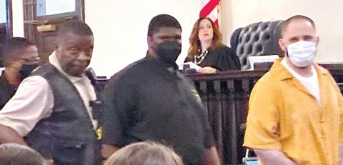 Christopher Demmon looks at and speaks to the victim’s family as he is escorted out of the courtroom. LYNN HOBBS/Staff