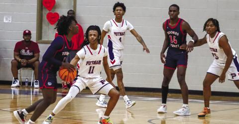 Messiah Walker (11) at the top of the key defending a Toombs County player in the first round of the 2022-23 Class AA state playoffs. LANCE McCURLEY/Staff