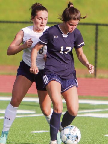 Putnam County senior Lily Frisch (13) tries to dribble to ball away from a Jeff Davis defender. (LANCE MCCURLEY/Staff)