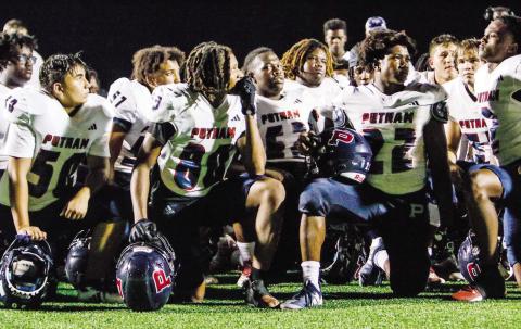 Putnam County players listen to head coach Joel Harvin’s postgame speech this past Friday after losing to Greene County. (LANCE MCCURLEY/Staff)