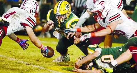 Tyler Middleton (center) made the effort for Gatewood Friday night, but the visiting Spartans came up with the ball after a lategame fumble by Gators quarterback Ames Johnson. IAN TOCHER/Staff