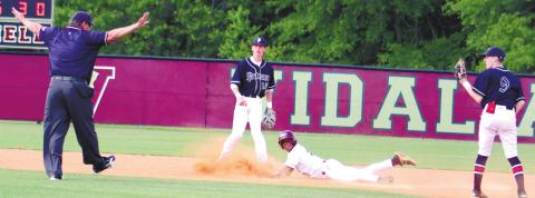 Two Putnam County infielders look on as an umpire calls the Vidalia baserunner safe at second. ARELLA CASH/Staff
