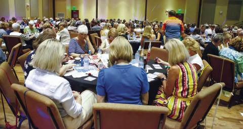 Participants are deep in concentration on the bingo cards as each number is announced. (LEIGH LOFGREN/Staff)