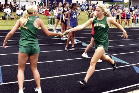 The Gatewood girls’ 800-meter relay team completes a handoff during the region meet held last Thursday in Eatonton. IAN TOCHER/Staff