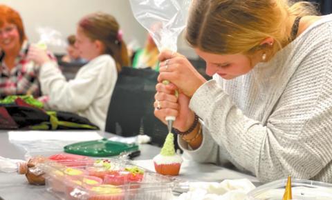 Student decorating a cupcake during the Holiday Cupcake Decorating course taught by six-time Food Network Champion, Reva Alexander Hawk. CONTRIBUTED