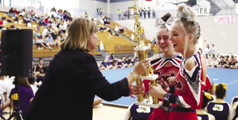 Members of the PCHS Cheer team hold up the Region 4-AA trophy.