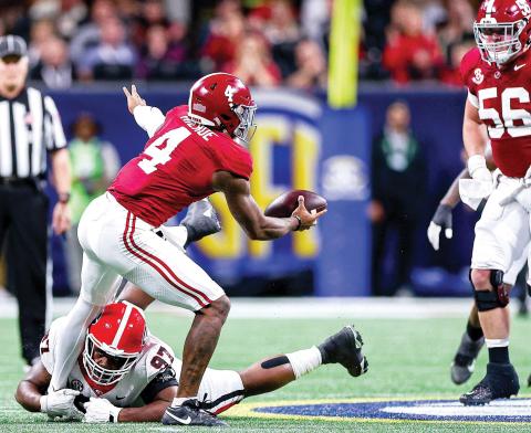 Georgia defensive lineman Warren Brinson (97) recorded a sack on Alabama quarterback Jalen Milroe (4), a tackle for loss and three tackles in the 2023 SEC Championship game in Atlanta. TONY WALSH/UGAAA