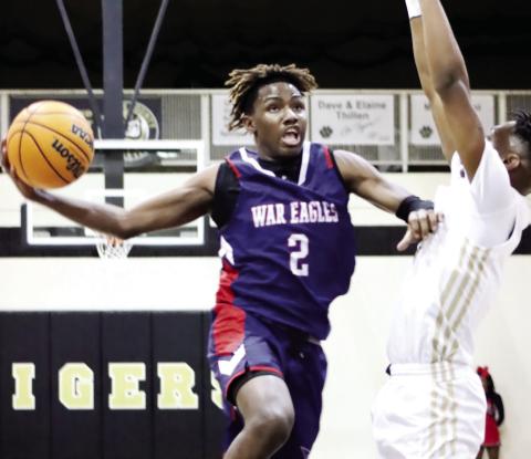Bonner (2) goes up for a layup against Greene County’s Steve Miller in a win last season. ARELLA CASH/File photo