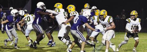 Gatewood quarterback Ames Johnson (10) scrambles behind his offensive line during the GIAA Class AA semifinal game Nov. 25, against Central Fellowship Christian Academy in Macon. DAWN SINCLAIR/Staff