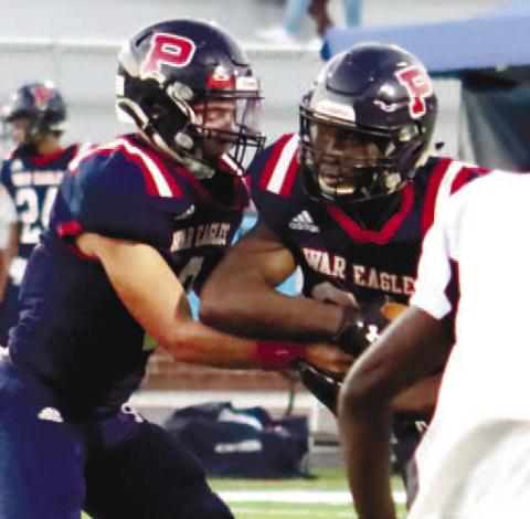 Quarterback Branan Griffin hands the ball off to Tamarion Peters in a game earlier this season. ARELLA CASH/Staff