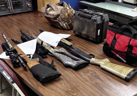 Eatonton police officers found these stolen rifles and a shotgun that two teens hid in the woods along with stolen bags of tools, trail cameras, and other hunting gear. The guns were loaded at the time. CONTRIBUTED/ EPD
