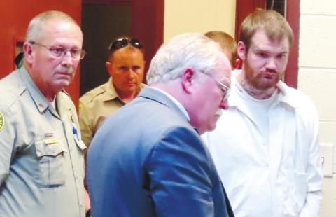 No longer wearing a dress shirt and tie as he did throughout the trial, Ricky Dubose, far right, is shackled and in prison garb as he is escorted out of Putnam County Courthouse to be taken to the Georgia Department of Corrections’ Special Management Unit in Jackson. He is led by Putnam County Sheriff Howard R. Sills as well as Sgt. Bob Rogers and Deputy Chris Donovan. COURT POOL COVERAGE