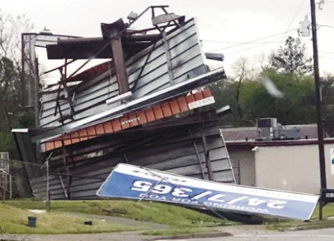 Twisted billboards were among signs of apparent tornado activity in Milledgeville. CONTRIBUTED