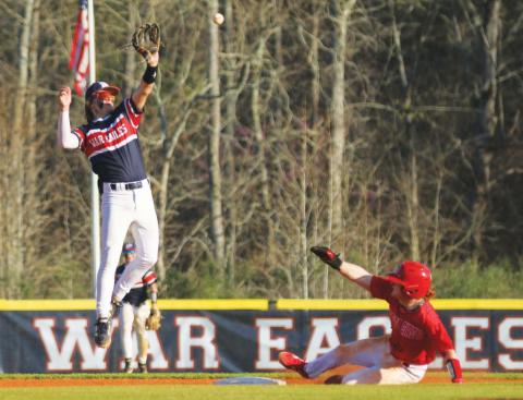 Putnam County’s Gates Lanzarone attempts to catch a ball in mid-air as a Social Circle player slides into second base safely. TREY NORRIS/Staff