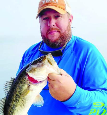 The author with a largemouth bass caught on a spoon. CONTRIBUTED