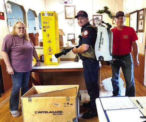 Last month, members of the Kinderhook Fire Association (KFA) donated a high-powered fire scene light and high-tech firefighting backpack to the Putnam County Fire Department. L-R: KFA Vice President Terea Jacobs with a PCFD firefighter and KFA President Elliott Perkins. (CONTRIBUTED)