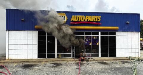 Smoke billows out as Eatonton Fire Department firefighter approaches the door of the NAPA Auto Parts store Nov. 19. COURTESY OF EATONTON FIRE DEPARTMENT