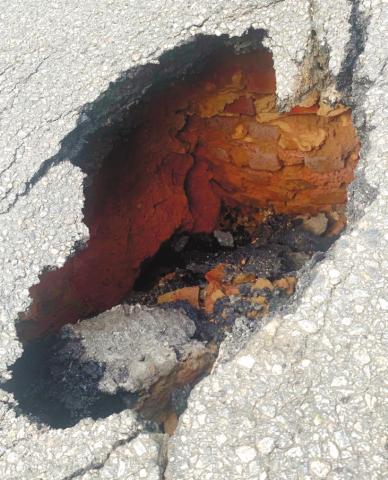 A small sinkhole at a sewer line in the middle of a downtown road is the cause of the intersection being closed several days. CONTRIBUTED