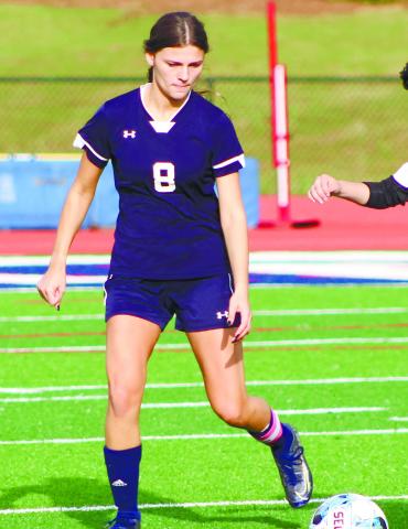 Senior Jenna McDerment (8) approaches to challenge a Greene County player. ARELLA CASH/ Staff