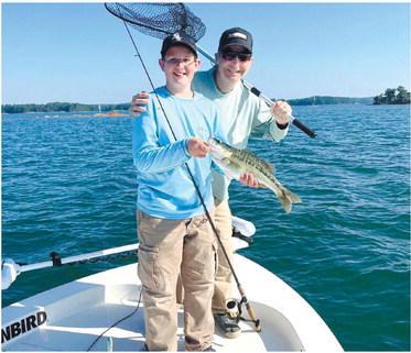 Henry Cowen and Beau with a nice top water spotted bass CONTRIBUTED