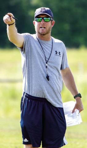 Putnam County head coach Joel Harvin directs his players while they go through a drill during a spring practice in May. LANCE McCURLEY/Staff