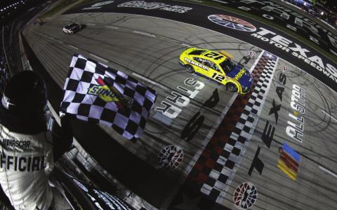Ryan Blaney, driver of the #12 Menards/Wrangler Ford, takes the checkered flag to win the Cup Series All-Star Race at Texas Motor Speedway Sunday. (Sean Gardner/Getty Images)