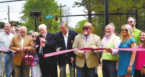 County Commission Chairman Billy Webster and, from left, Commissioners Bill Sharp, Gary McElhenney and Jeff Wooten cut the ribbon to commemorate the activation of the new traffic light at Scott Road and Lake Oconee Parkway Tuesday. T. MICHAEL STONE/Staff