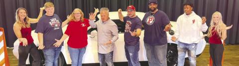 Mark the Magic Man (4th from left) poses with members of the Putnam County Touchdown Club at the end of his family show Saturday afternoon. IAN TOCHER/Staff