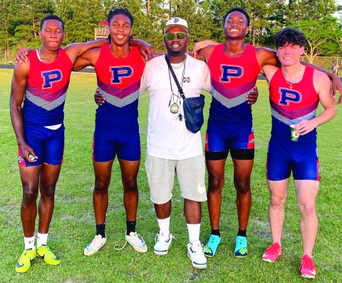 The Putnam County boys 4x400-meter relay team poses for a photo with coach Kedric Manning, celebrating their fifth-place finish at the state sectional meet. CONTRIBUTED