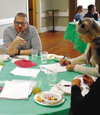 GaFCP Regional Manager Adam Swymer (center) joins a discussion in one of the small groups. LENA HENSLEY/Staff