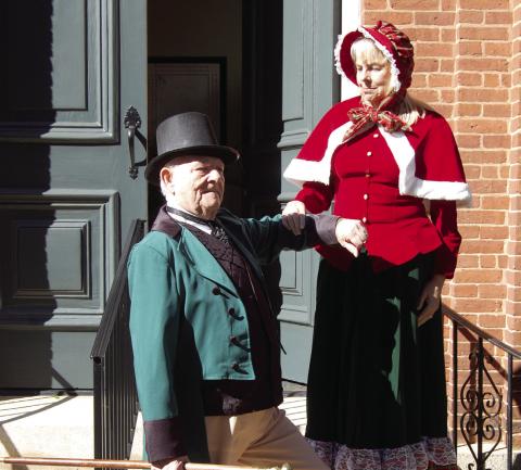 With both sporting periodcorrect attire, Rev. Meg Jackson Clark is assisted down the church steps by Spencer Hinds. CONTRIBUTED