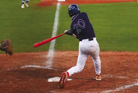 Putnam County senior Jacob Grimes (20) smacks a single to right field Feb. 27, in a loss to Athens Academy. LANCE MCCURLEY/Staff