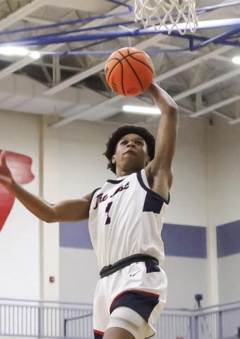 Putnam County senior guard Jeremy Banks goes up for a dunk during a game last season. Banks will take on a larger leadership role for the War Eagles this season as they look to build on last year’s run to the GHSA Class 2A Elite Eight. TREY NORRIS/Staff