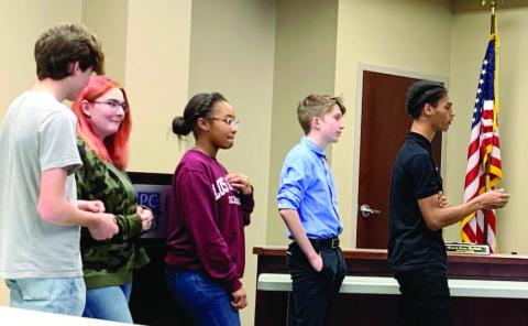 PCHS students Ty Young, Hunter Cousino, Taylor Wilson, Aidan Brock and Cameron Lawson tell the board about their experiences at the conference. BAILEY BALLARD/Staff