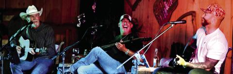 With his between-songs patter, Wynn Varble (left) kept his fellow songwriters (and the audience) laughing all night long with humorous stories that inevitably ended in a bizarre, unexpected twist. IAN TOCHER/Staff