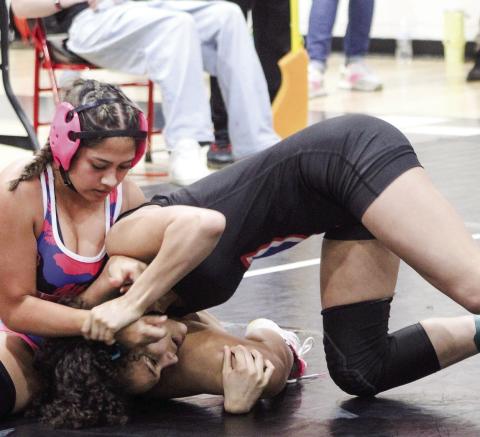 Putnam County’s Michelle Hernandez (left) tries to pin an opponent during a tournament match in the regular season. KIM CASH/ Contributed