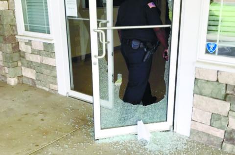 Glass in the entry doors of the community center at Jimmy Davis Park is shattered and scattered on the walkway after a rock was thrown through the doors. The rock was discovered all the way across the interior room, suggesting it slid that far when thrown, authorities say. CONTRIBUTED/EPD