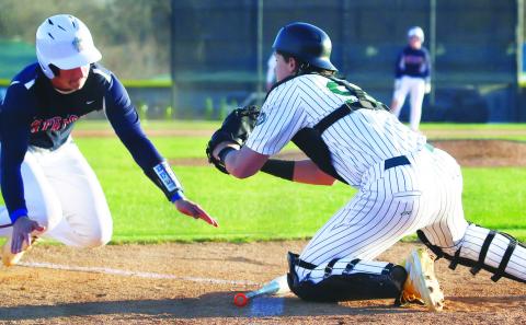 Gatewood catcher Connor Mitchem blocks a Strong Rock runner at the plate in the Gators’ season opener last week in Eatonton. TREY NORRIS/Staff