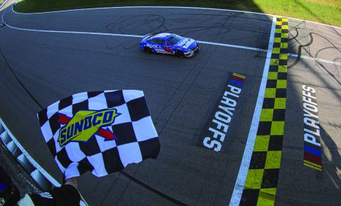 Bubba Wallace, driver of the #45 ROOT Insurance Toyota, takes the checkered flag to win the Cup Series Hollywood Casino 400 at Kansas Speedway Sunday. (Meg Oliphant/Getty Images)