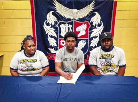 Putnam County boys basketball senior Jmari Greene (center) recently signed a letter of intent to play for Andrew College. CONTRIBUTED