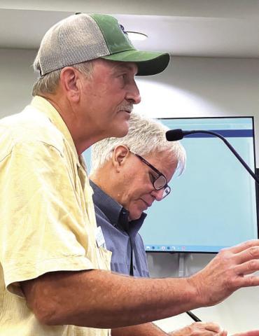 Land developer George Kelecheck (foreground) and Greg Ramsey, design chief of Asheville, N.C.based Village Habitat Design, gave an extensive presentation about the benefits of long-term development planning to the Putnam BOC. IAN TOCHER/Staff
